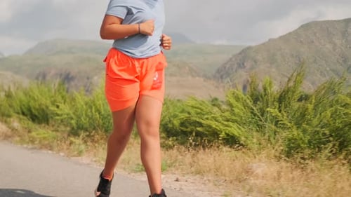 Woman Running on Rural Mountain Road