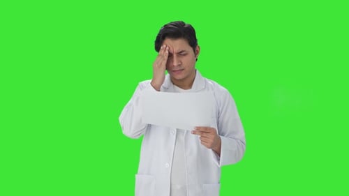 Stressed Indian scientist reading research papers Green screen