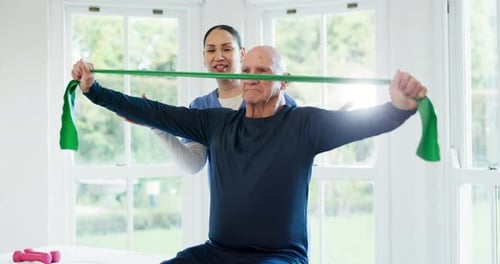 Senior Man Exercising with Assistance of Physical Therapist
