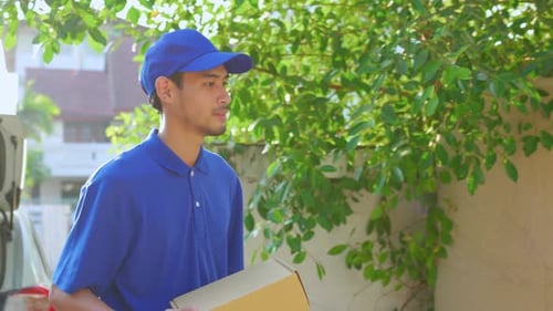 Delivery Man Delivering Package to Suburban Home