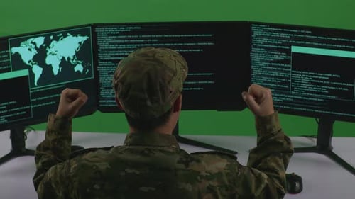Man Soldier Celebrating And Dancing While Write Code With Multiple Computer Screens In Green Screen