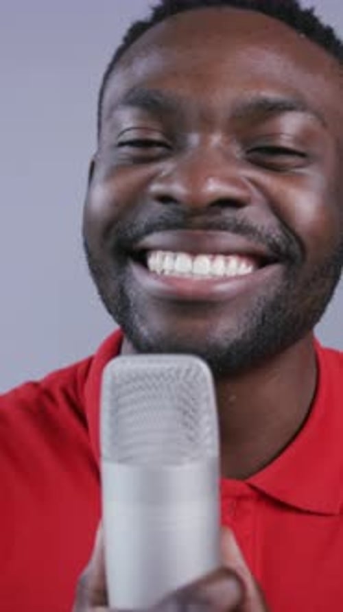 Man Singing Into Microphone With Big Smile