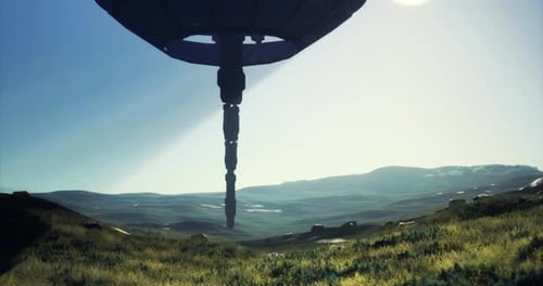 Mysterious Alien Ship Hovering Above Lush Green Valley at Dawn