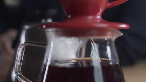 Coffee Brewing with Red Filter into Glass Carafe