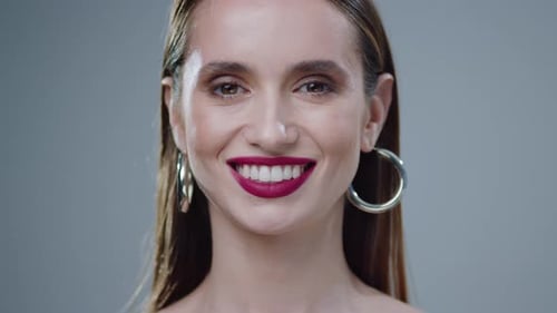 Glamorous Woman with Bold Make-Up and Hoop Earrings