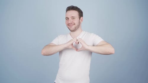 Man Smiling Making Heart Shape with Hands