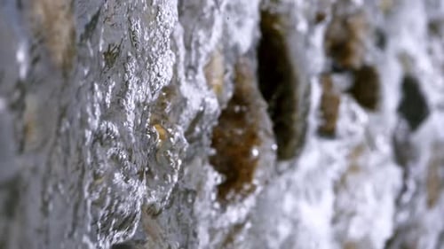 Vertical of a clear stream running through stone boulders Abundant river flowing in slow motion. Wil