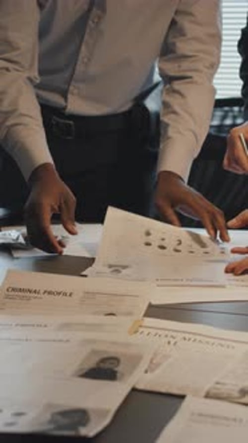 Detectives Analyze Criminal Profiles at Workplace