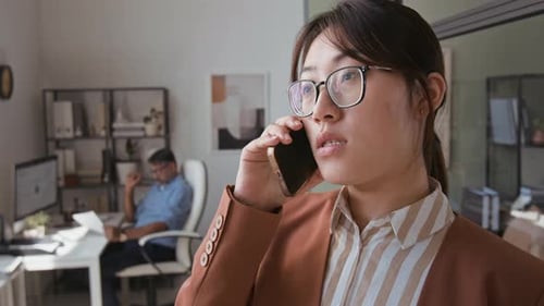 Businesswoman Talking on Phone in Modern Office