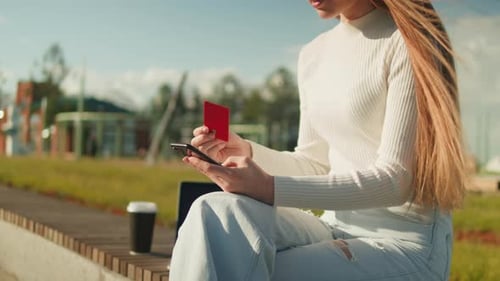 Online Shopping Woman Using Credit Bank Card and Smartphone Outdoor Bank Application Buying Clothes
