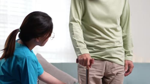 Healthcare Professional Examining Senior Man's Leg