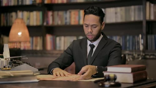 Middle Aged Lawyer Reading Book in Court
