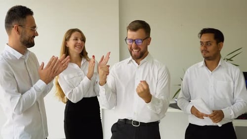 Business Team Celebrating Success in Modern Office