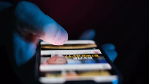 Hand Scrolling on a Phone at Night