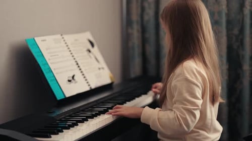 Child Plays Piano at Home
