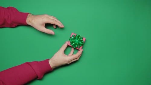 Hands Giving a Wrapped Birthday Gift