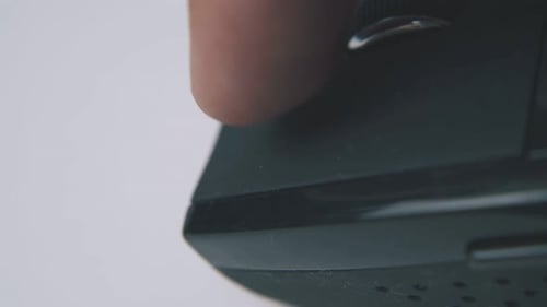 Person Uses Computer Mouse with Wheel on White Surface