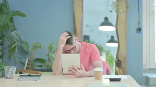 Man Reacts to Bad News on Tablet Device