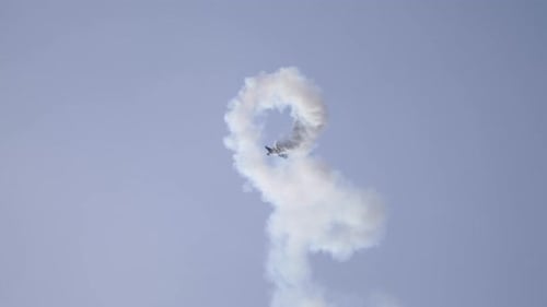 Corkscrewing Aerobatic Airplane Spiraling Down with Smoke Trail at Airshow