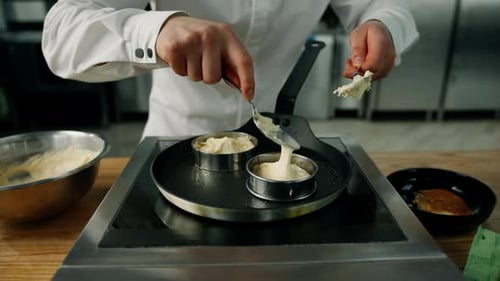 Chef Baking Savory Pancakes in Molds on Pan