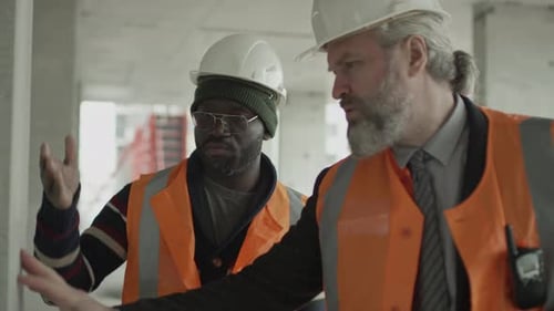 Two Men Discuss Building Construction