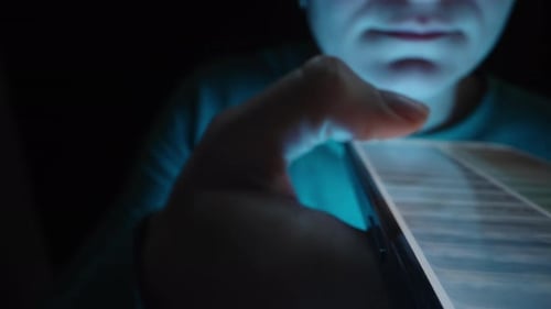 The young woman Quickly Scrolls Through Photos on the Social Network on her Smartphone. Slider panor