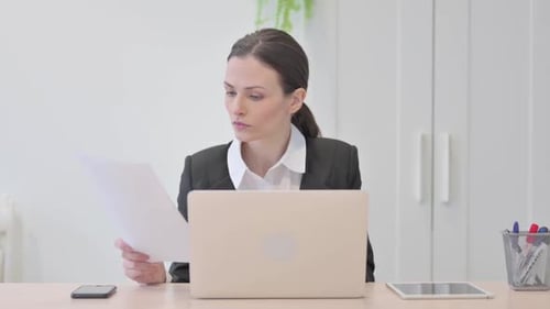 Professional Woman Working at Desk with Laptop