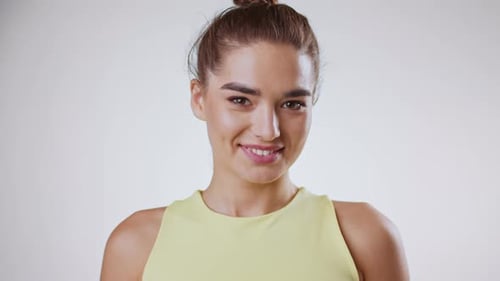 Woman Smiling in Close Up Portrait Against White Background