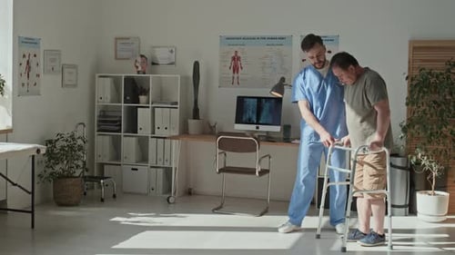 Doctor Caring About Mature Patient at Hospital