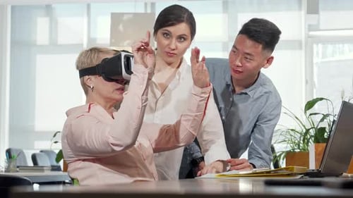 Mature Businesswoman Immersed in 3D Virtual Reality at the Office
