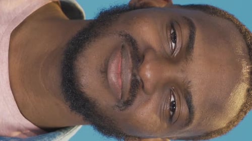 Smiling Man Close-up Portrait on Blue Background