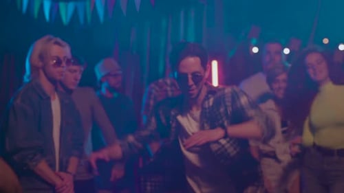 Enthusiastic young adults dancing at a lively party