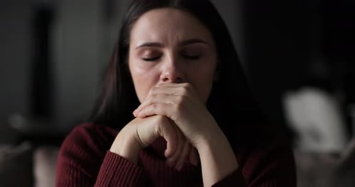 Woman Covers Her Face with Her Hands