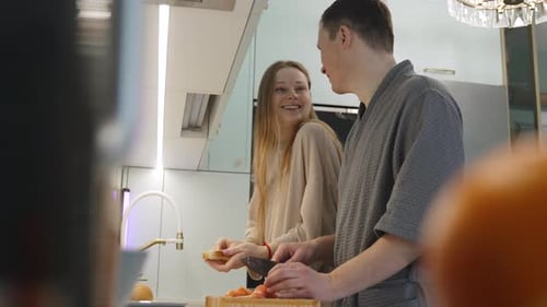 Couple Prepares Food Together in Modern Kitchen
