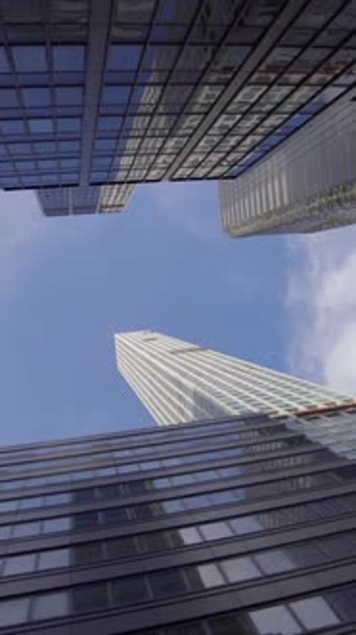 A Stunning Skyward View Depicting Modern Skyscrapers That are Surrounded By Glass Panels