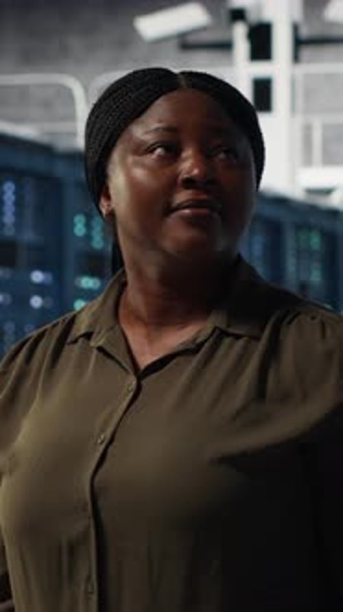 Vertical Video Portrait of Smiling Admin Walking in Data Center Overseeing IT Infrastructure
