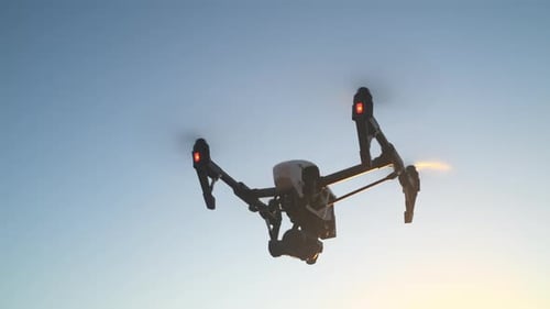 Drone Flying Silhouetted During Golden Hour
