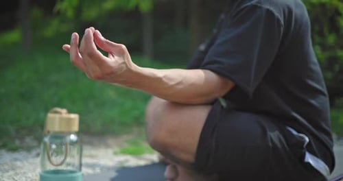 Hands Closeup Young African American Spirituality Man Meditating Yoga Asana Sitting in a Park
