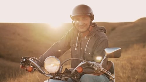 Smiling Young Adult on Vintage Scooter at Sunset