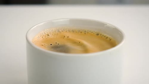 Close Up Of Steaming Coffee In Mug