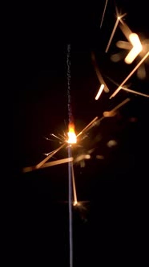 Bengal light sparkler illuminating the night with vibrant sparks