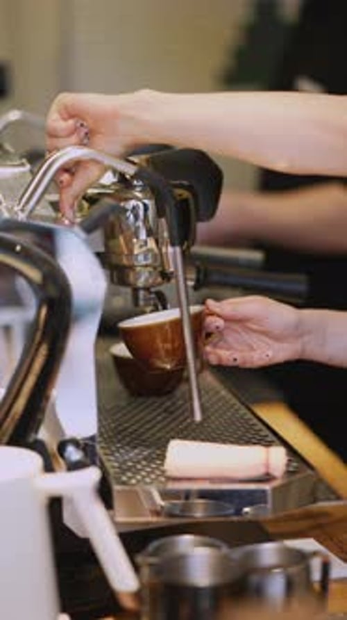 Barista Makes Espresso Coffee in Cafe Setting