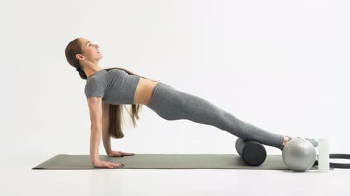Young Beautiful Girl Wearing Fashion Sportswear Doing Fitness on Mat at Gym