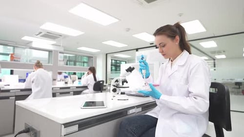 Focused Woman Working in Brightly Lit Laboratory
