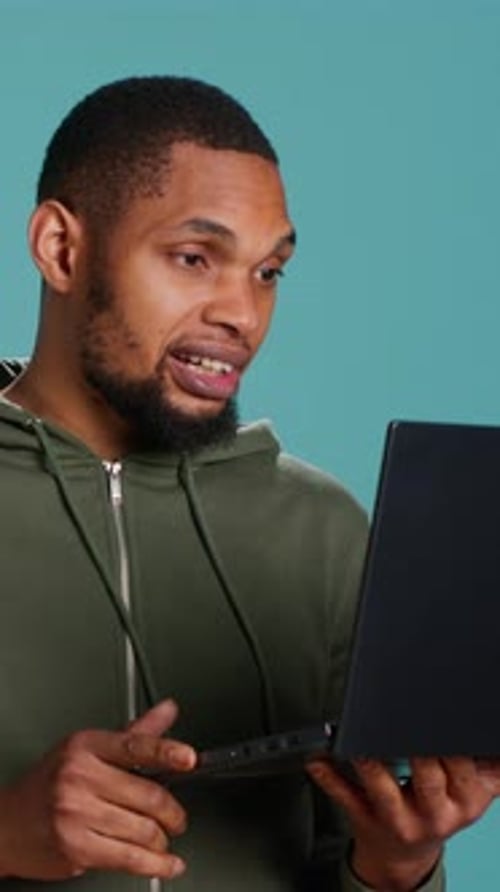 Young Adult Explaining Something on Laptop