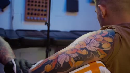 Hands of Tattoo Specialist Disinfecting Clients Skin