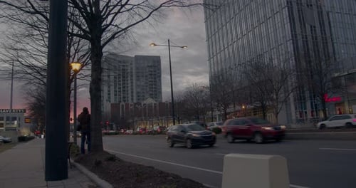 Cars pass by a photographer in the city of Buckhead, Atlanta