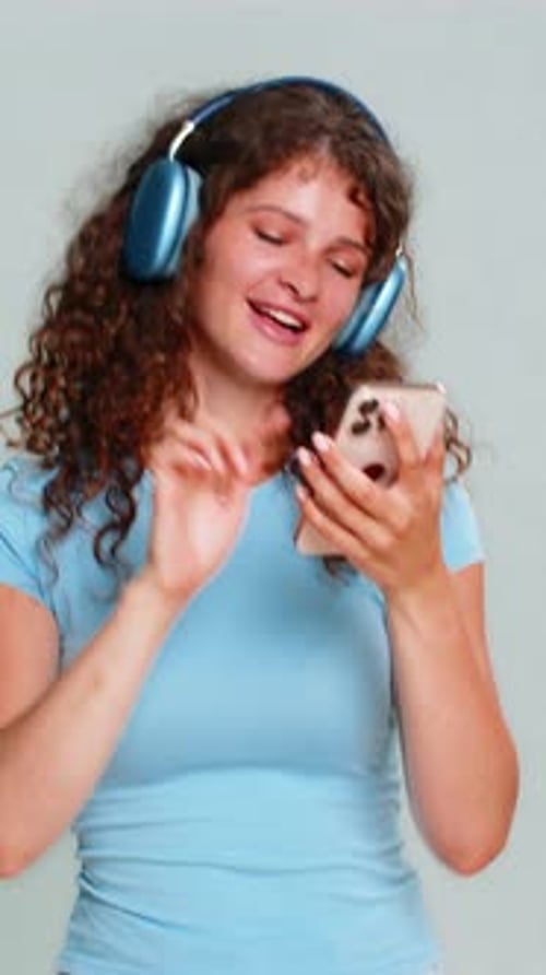 Woman Listening to Music and Dancing with Phone