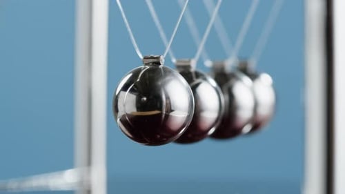 Newton's Cradle Demonstrates Conservation of Momentum and Energy
