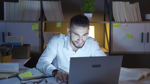 Young Man Communicating Via Laptop at Desk